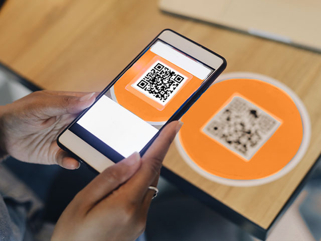 Person scanning QR code with phone