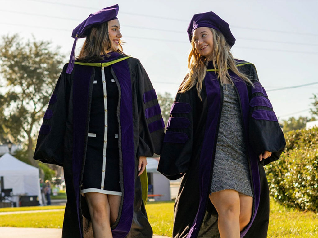 (Left to Right) Christina Lanzilla and Stephanie Maines pose for graduation photos in celebration of completing FAMU College of Law.