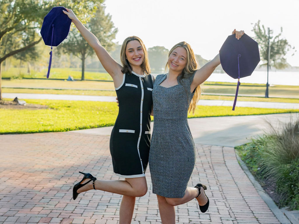 (Left to Right) Christina Lanzilla and Stephanie Maines pose for graduation photos in celebration of completing FAMU College of Law.